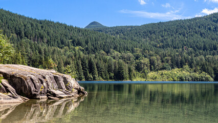 Hick lake in Sasquatch provincial park showcasing its calm waters, wooded shoreline, and campground...