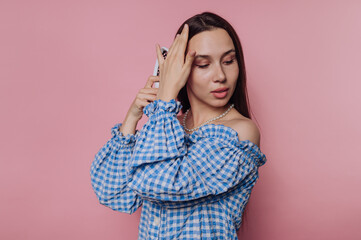 Fototapeta premium Woman in Blue Checkered Blouse with Phone