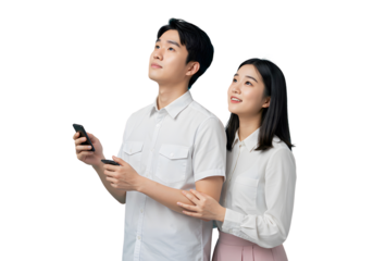 A young Asian couple, light-skinned, in white shirts, looks upwards