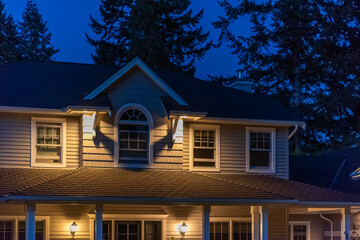 Fragment of luxury house with nice green Summer landscape at night in Vancouver, Canada, North America. August 2025.