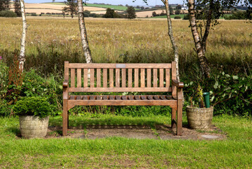 Wooden Public Park Bench Seat at a Rural Countryside Location