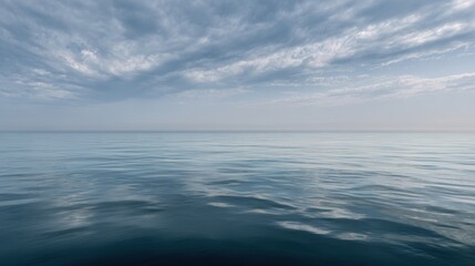 Fototapeta premium Serene water surface reflecting a cloudy sky, showcasing the beauty and tranquility of nature's water bodies.