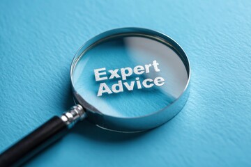 A magnifying glass focuses on Expert Advice against a textured blue background