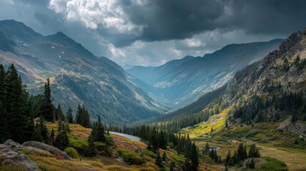 Fototapeta premium Dramatic Rocky Mountain Pass Under Moody Clouds in Scenic Landscape