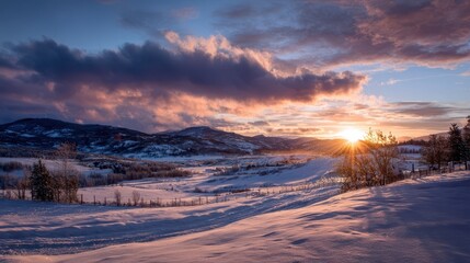 Scenic Sunset Over Snow Covered Hills in Beautiful Winter Landscape