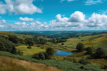 Naklejka premium Vast rolling green hills under a bright blue sky filled with fluffy white clouds