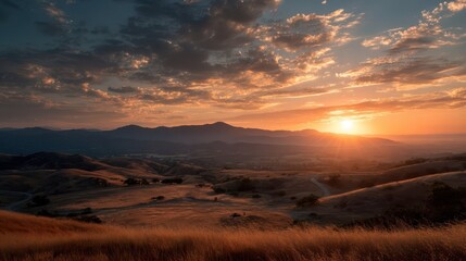 Obraz premium Breathtaking Sunset View from Hilltop with Warm Colors and Clouds