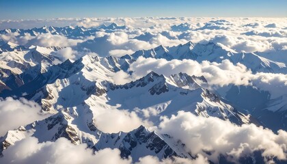Obraz premium Snowy mountain peaks above clouds