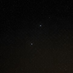 Fototapeta premium Celestial conjunction of two bright planets or stars shining in the vast, star-studded night sky