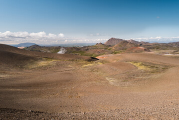 Barren Volcanic Landscape with Rolling Hills under Clear Sky