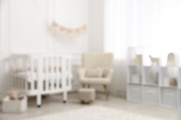 Baby room interior with crib and other furniture, blurred view