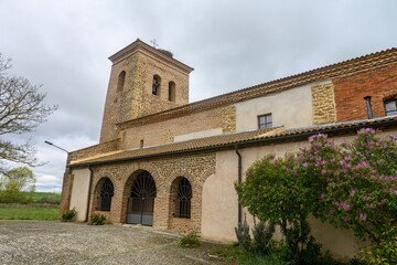 Fototapeta premium Church of Santa Ines in Villambroz, Palencia, with brick and stone bell tower
