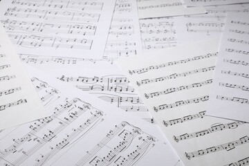 Obraz premium Sheets with musical notes as background, closeup