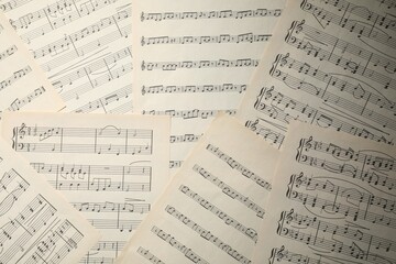 Fototapeta premium Sheets with musical notes as background, top view