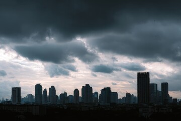Dramatic overcast sky looms over a silhouetted cityscape of tall buildings under a gloomy atmosphere