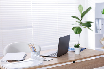Doctor's workplace with modern laptop on desk in office
