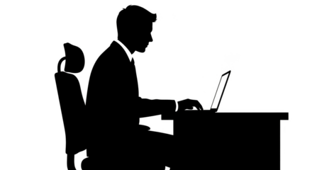 Silhouette of a man using a laptop