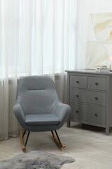 Stylish furniture near window with curtains in living room. Interior design