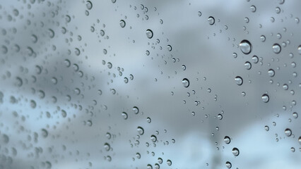 Water droplets clinging to a car window, creating a soft, moody atmosphere after rainfall