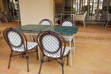 Classic white steel chair and table in the garden,empty white vintage chairs in the garden,decoration english garden concept.