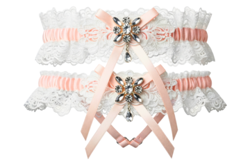 White lace wedding garter set with pink ribbon and crystals isolated on a transparent background