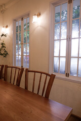 Wooden table and chair set in cozy room,indoor seating for restaurant or cafe.