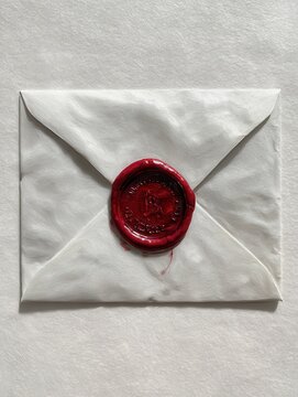 sealed envelope red wax seal white backdrop mystery important