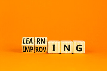Doing or learning symbol. Turned wooden cubes and changed the word Doing to Learning . Beautiful orange table orange background. Educational business doing or learning concept. Copy space.