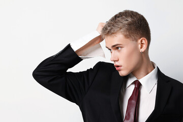 Handsome young man wearing stylish suit on white background