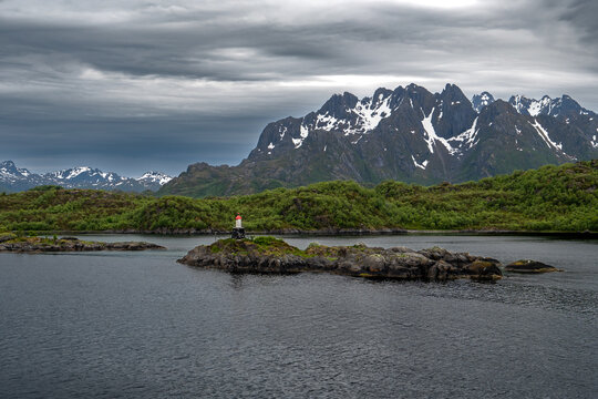 Coastal Landscape With Lighthouse And Snowy Mountains Near Stokmarknes At The Lofoten In Norway