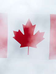 Vibrant Canadian flag gracefully waving amidst a misty backdrop during a serene morning
