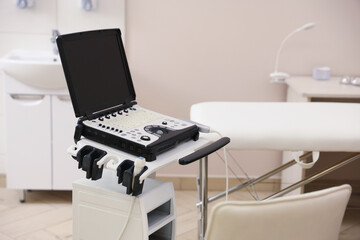 Modern ultrasound machine and examination bed in clinic