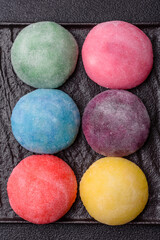 Japanese mochi, ice cream or Asian sweets with fruit filling. Mochi of different colors