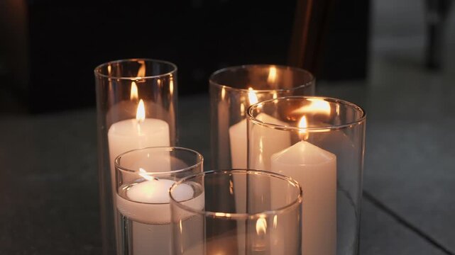 A serene arrangement of lit candles in glass holders, perfect for creating a warm and inviting atmosphere.