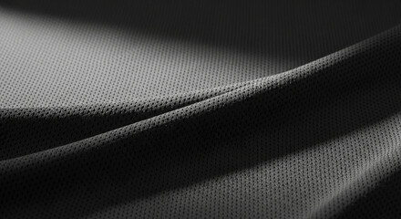Close-up of dark gray fabric texture with subtle folds, showcasing a breathable, perforated design suitable for sportswear or technical apparel mockups
