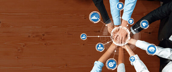 This image showcases hands coming together in a collaborative effort, symbolizing teamwork and...