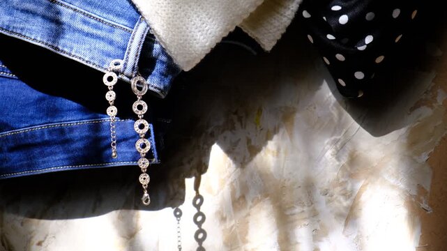 Jeans and jewelry, Outfit in home wardrobe. Shop, store, boutique, showroom. Autumn or winter	