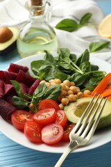 Different healthy vegetarian food on light blue wooden table, closeup