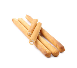 Many delicious grissini sticks isolated on white