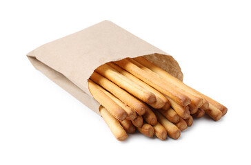 Delicious grissini sticks in paper bag isolated on white