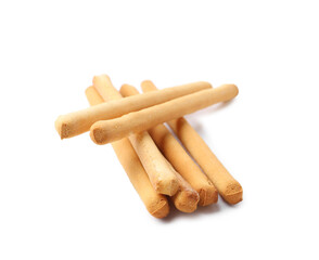 Many delicious grissini sticks isolated on white