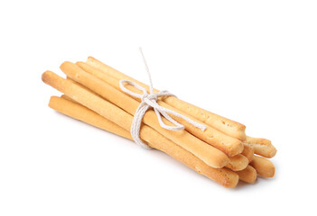 Many delicious grissini sticks isolated on white