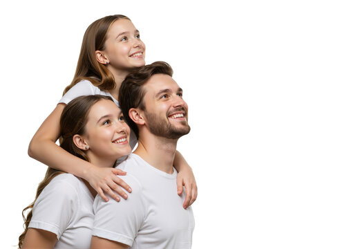 Optimistic family portrait of a handsome father and his two beautiful daughters looking up with joy on a white background.