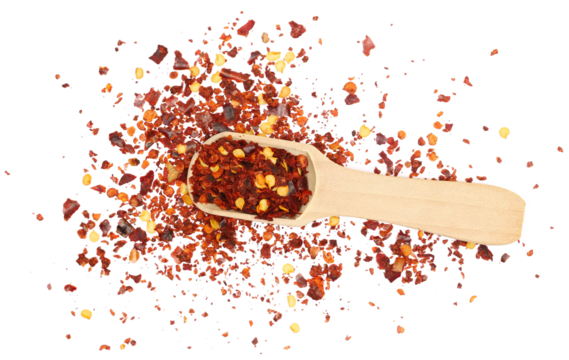 Spicy chili red pepper flakes, chopped, milled dry paprika pile in wooden sppon isolated on white, top view