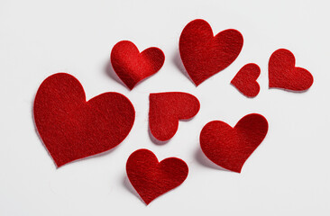 Fototapeta premium Felt red hearts floating on a transparent background, in a flat lay composition, heart, love, valentine, romance, day, hearts