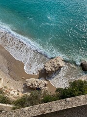 Cliff view overlooking beach, rocks, sea and waves