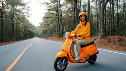 Joyful ride on orange scooter through scenic forest road in autumn