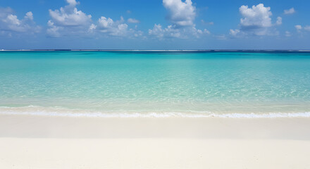 Fototapeta premium A tranquil tropical beach with pristine white sand, clear turquoise water, and a blue sky with clouds.