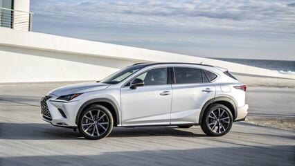 Obraz premium Silver crossover vehicle parked by a modern white building with an ocean background