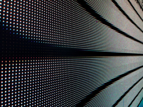 Close-up of illuminated LED display panel with grid pattern